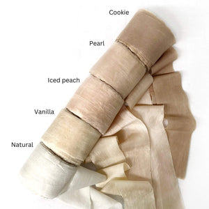 muted brown pearl pink soft iced peach vanilla natural sari silk rolls laying in group photo on white background