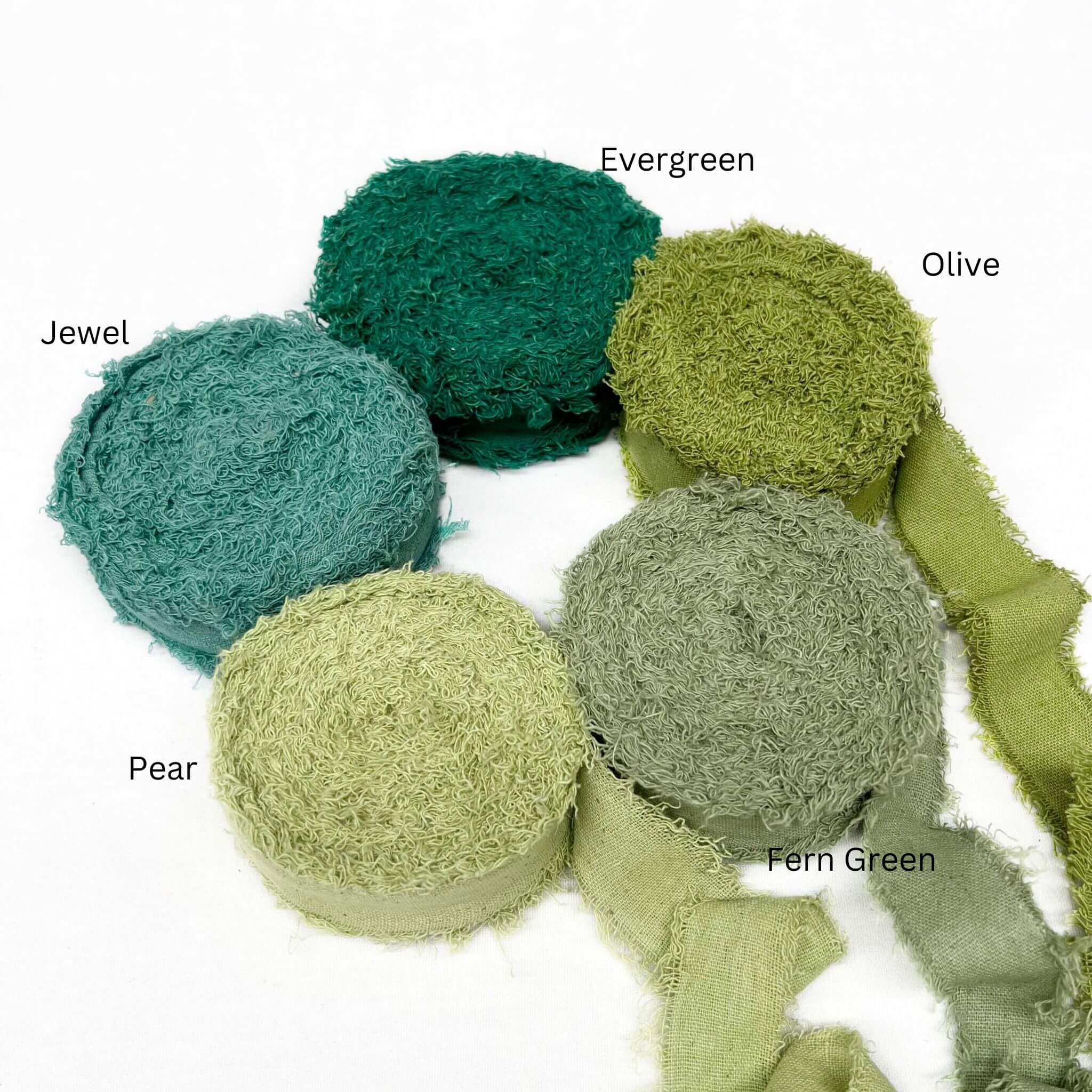 deep green olive green vintage green pear jewel green wide frizz ribbon in group photo three rolls unravelled to show texture