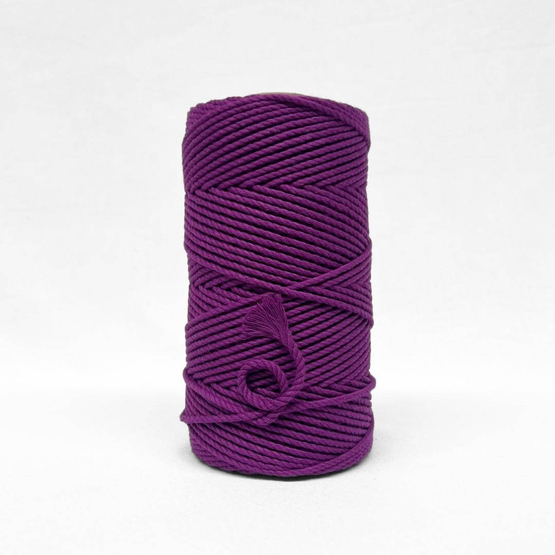 one roll of vibrant grape purple 4mm recycled macrame cord in white background small brushed piece showcasing products softness