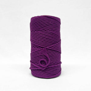 one roll of vibrant grape purple 4mm recycled macrame cord in white background small brushed piece showcasing products softness