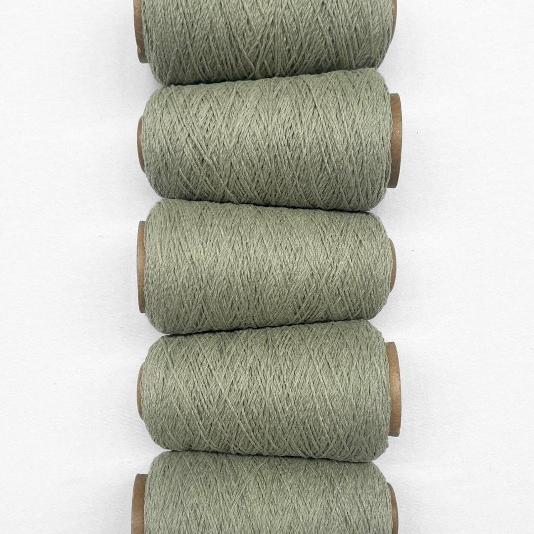 5 rolls of sage green wool rope laying side by side in flat lay image on white background