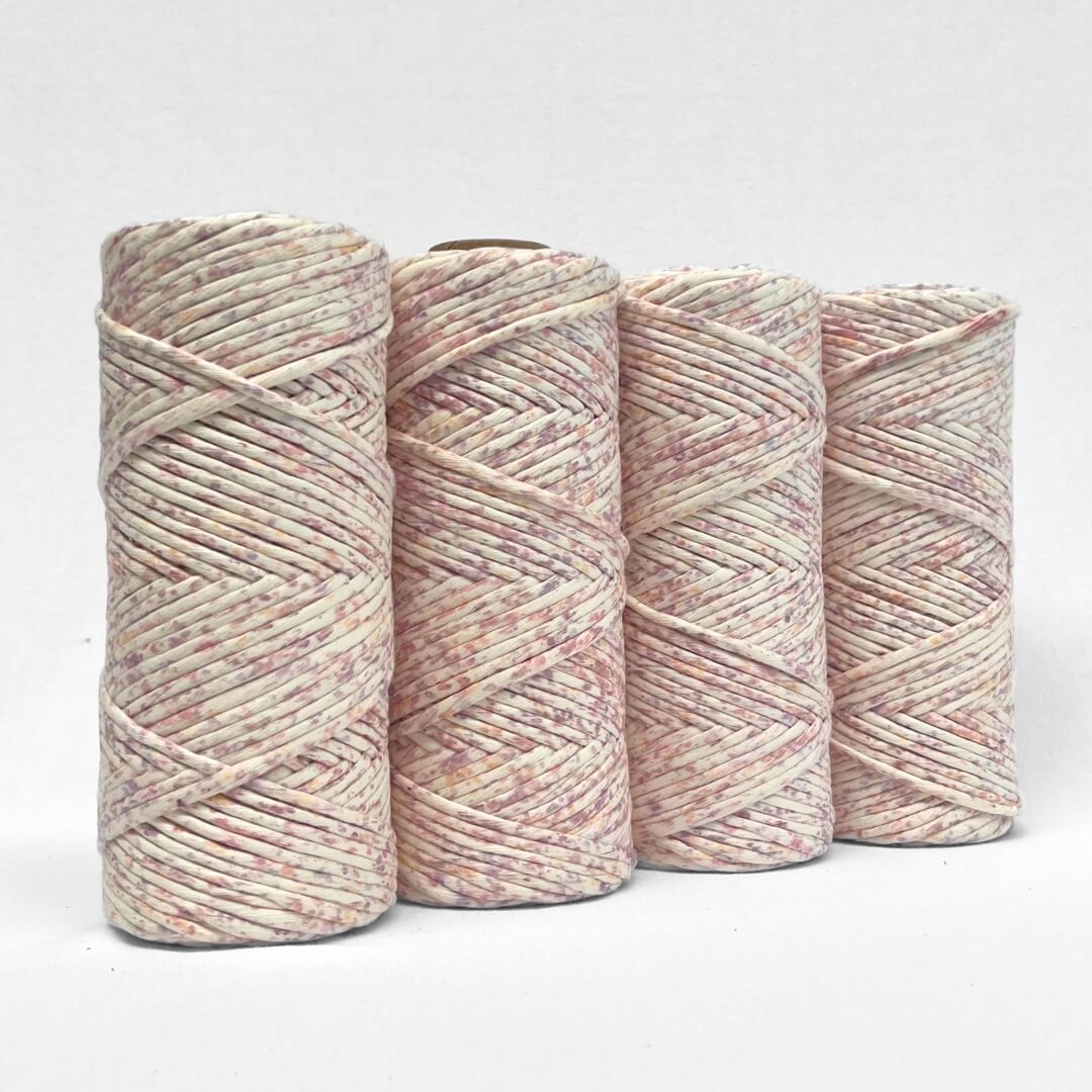 four rolls of confetti contton string in lilac lover colour way on white background