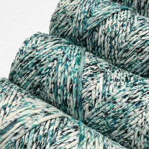 close up image of four rolls of aura blue confetti cotton cord 4mm laying flat on white background