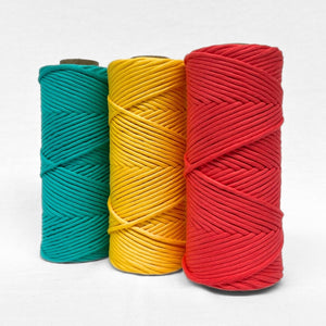 combination photo of three cotton string rolls in wilf watermelon daffodil yellow and turquoise standing side by side on white background showing complementing colours