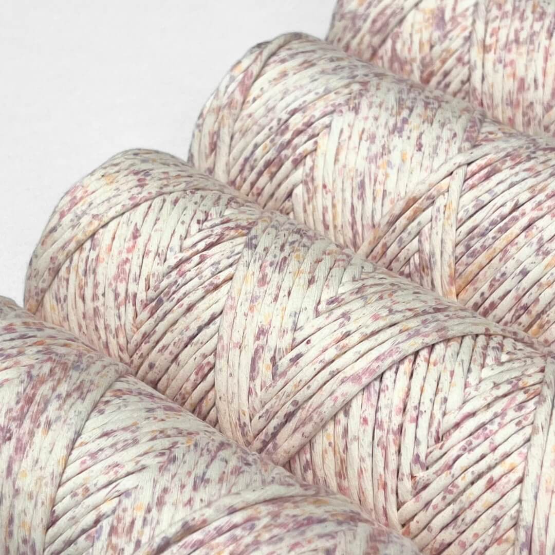 four rolls of confetti contton string in lilac lover colour way on white background