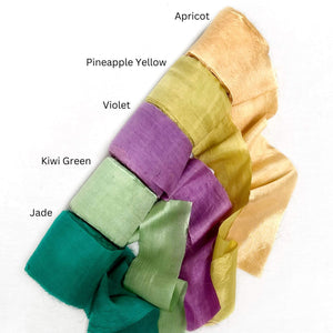 apricot orange pineapple yellow violet purple kiwi green jade deep green silk rolls for diy craft on white background