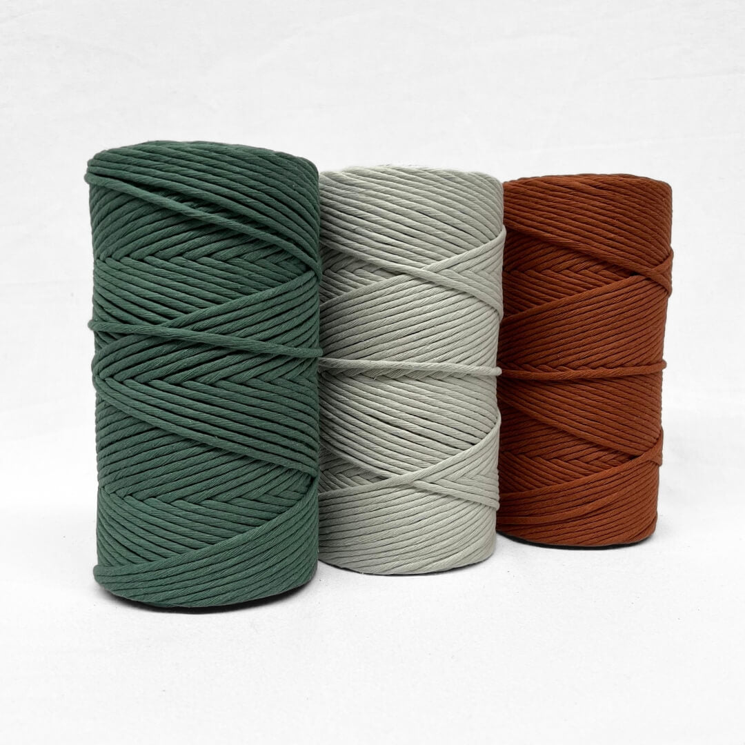 rust brown 3mm and 5mm string cotton rolls standing side by side on white wall