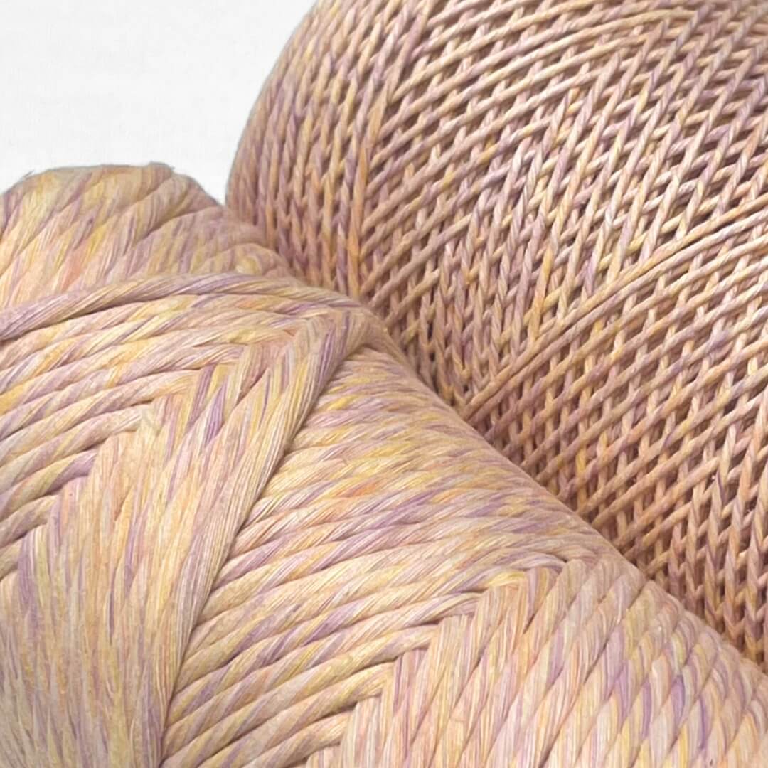 pastel lilac and orange mixed macrame string in 4mm and 1.5mm stnaind on white background