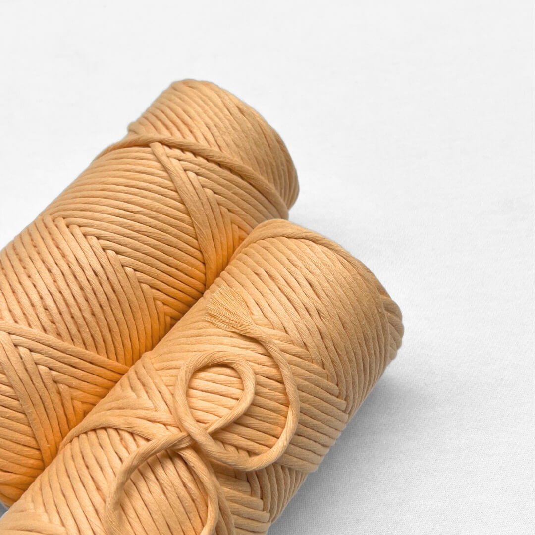 two rolls of pastel orange laying flat on white background