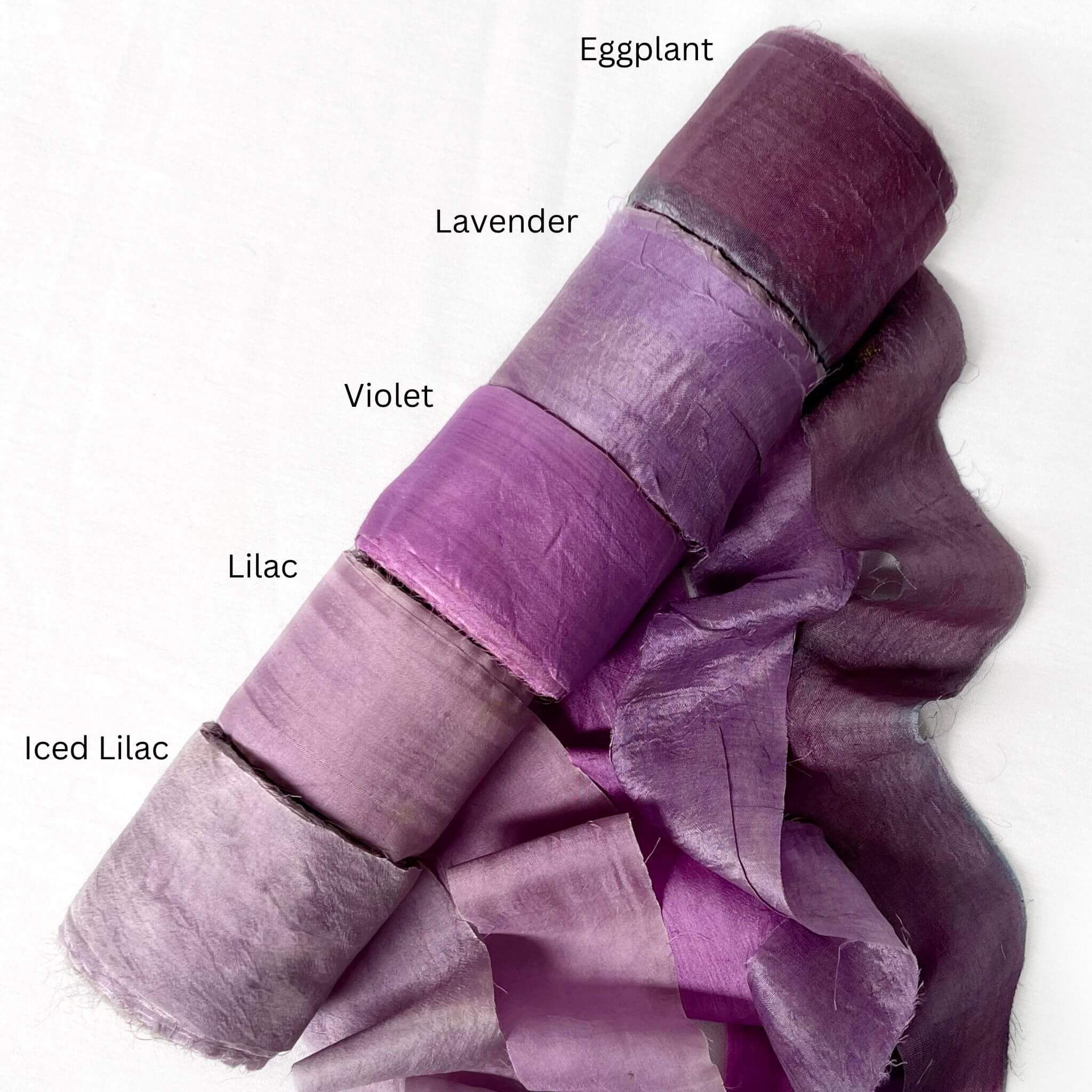 eggplant deep purple lavender vibrant purple lilac sift purple group image of silk ribbon rolls for gift wrapping on white background