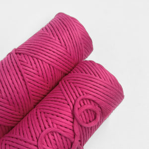 two roll of neon pink cloud 9 string on white background