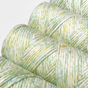 close up of lime splice confetti confetti string on white background