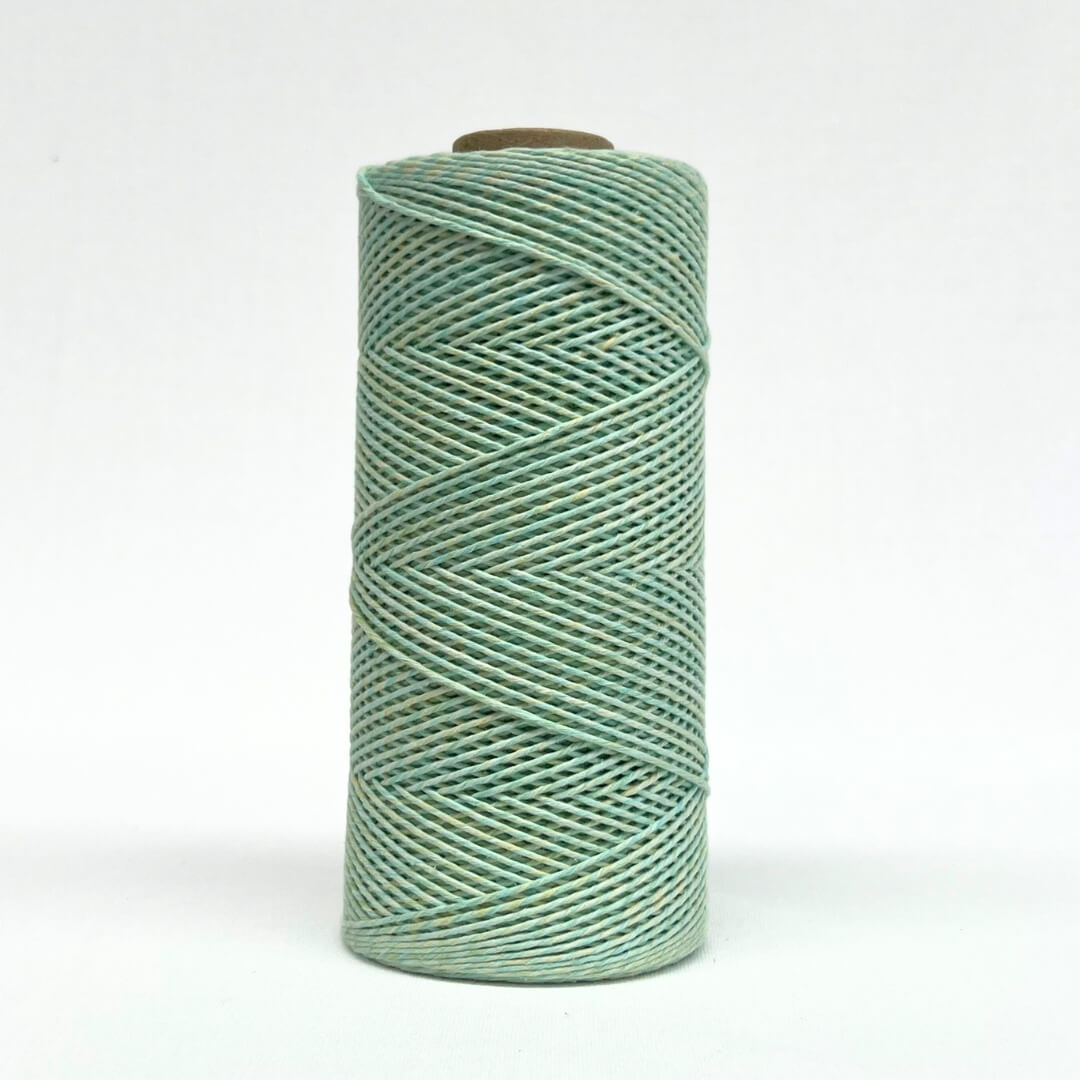 roll of 1.5mm lime and yellow mixed amcrame cord standing on white background