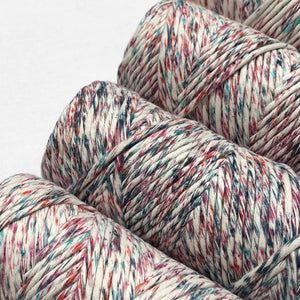 four rolls of harlequin light colour way laying flat in zoomed image on white background