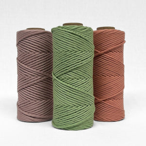 three rolls of cloud 9 cord in lemongrass smokey lavender and rose wood standing upright on white wall showcasing complementing colours