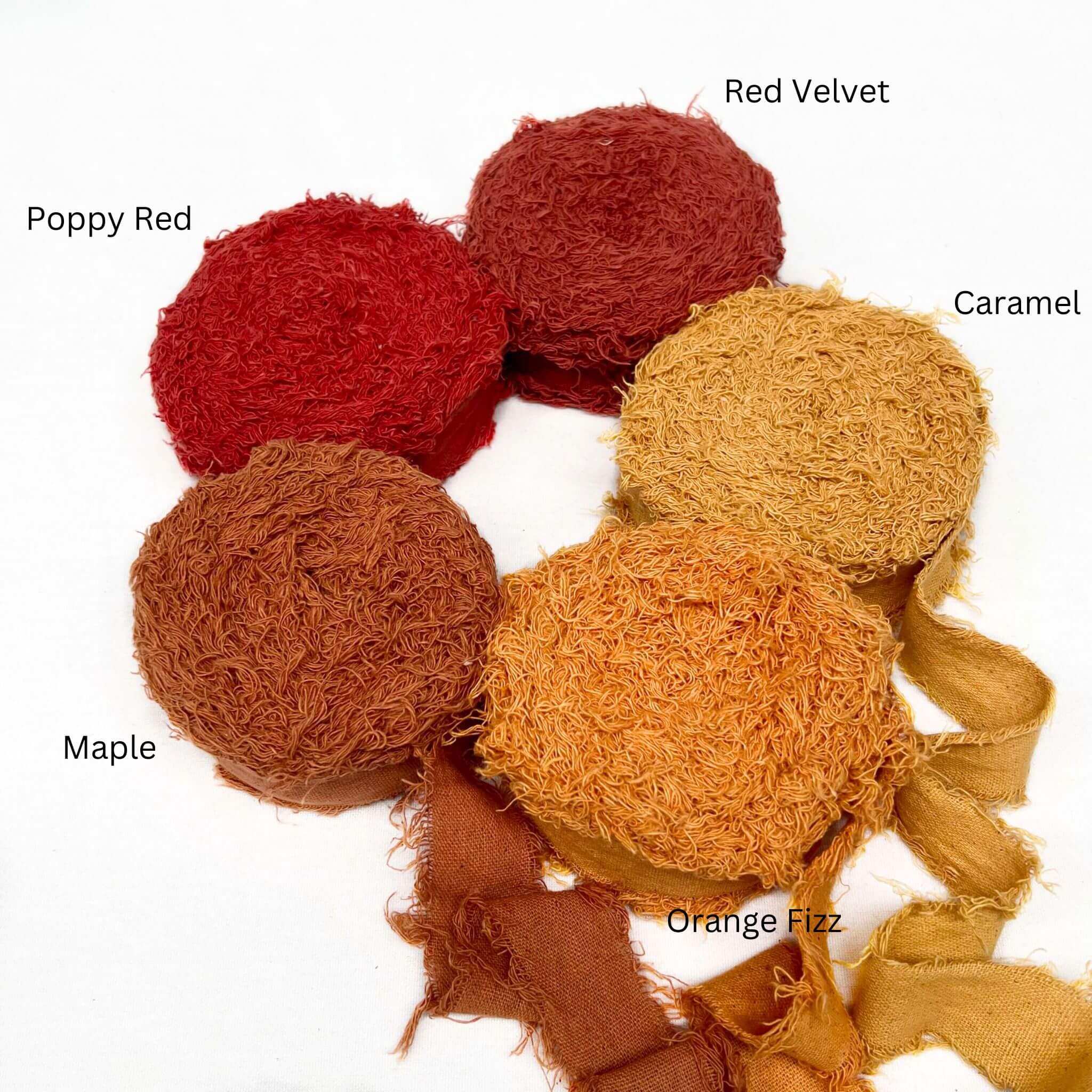 poppy red muted red caramel vibrant orange deep maple orange cotton frizz ribbon in group pohoto three rolls unravelled to sow frizzy nature