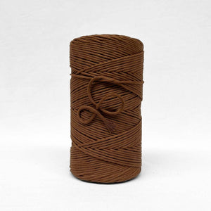 3mm cotton string in chocolate dark brown on white backdrop showing up close texture