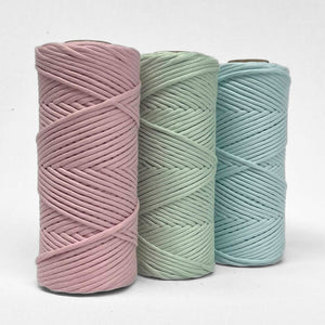 three rolls of 4mm string in pink mint and blue frost stading upright on white background showing complementing colour palette