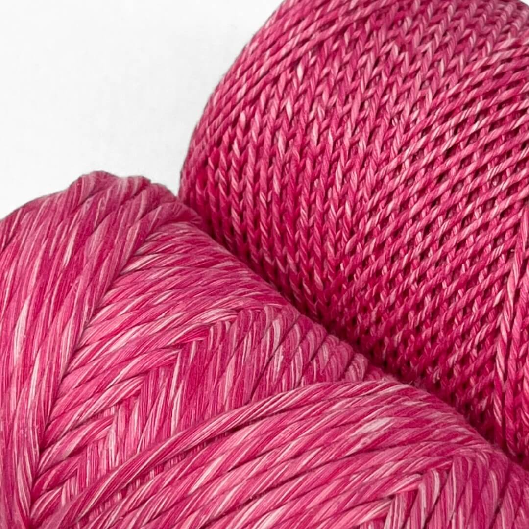 Hot pink pretty pink mixed macrame cord two rolls 1.5mm and 4mm standing side by side with white background