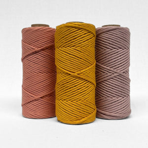 7c three rolls of macrame cord in marigold smokey lavender and rose wood staining straight up on white background