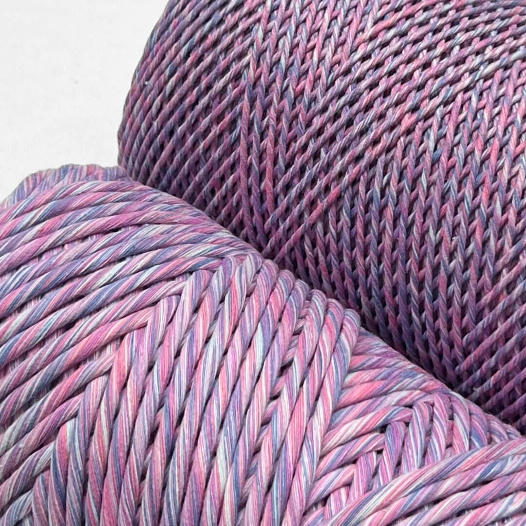 two cones of mixed macrame string in lavender skies colour shpwing a 1.5mm and 4mm variant on white back ground'
