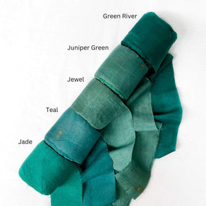 moody green colours river juniper jewel teal jade green wide silk ribbon on white background showing softness