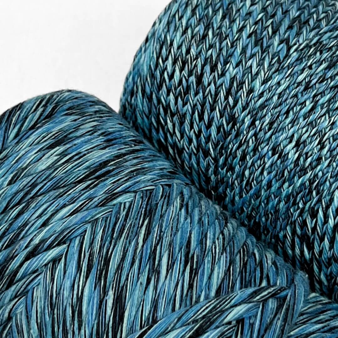 1.5 and 4mm rolls of cosmic blue mixed cotton string for weaving and macrame on white background