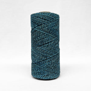 1.5mm blue and black two toned recycled macrame cord close up image showcasing the unique detail of the rolls on white background