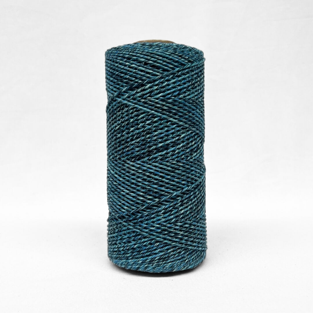 1.5mm blue and black two toned recycled macrame cord close up image showcasing the unique detail of the rolls on white background