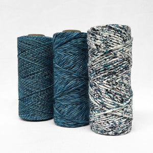 three rolls of the different versions of confetti cosmic blue string including 1..5 mixed 4mm mixed and confetti on white background