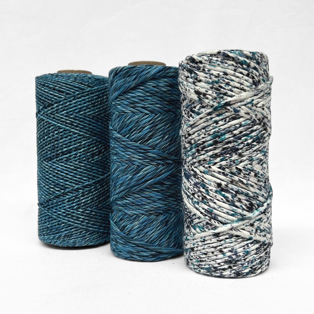 three rolls of the different versions of confetti cosmic blue string including 1..5 mixed 4mm mixed and confetti on white background