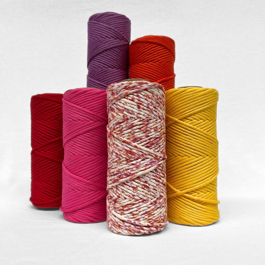 combination image showing sunburst macrame confetti cord with its five matching solid colours standing up on white background