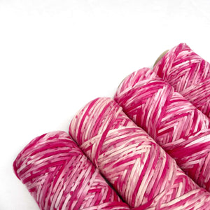 pink macrame cord laying flat on white background