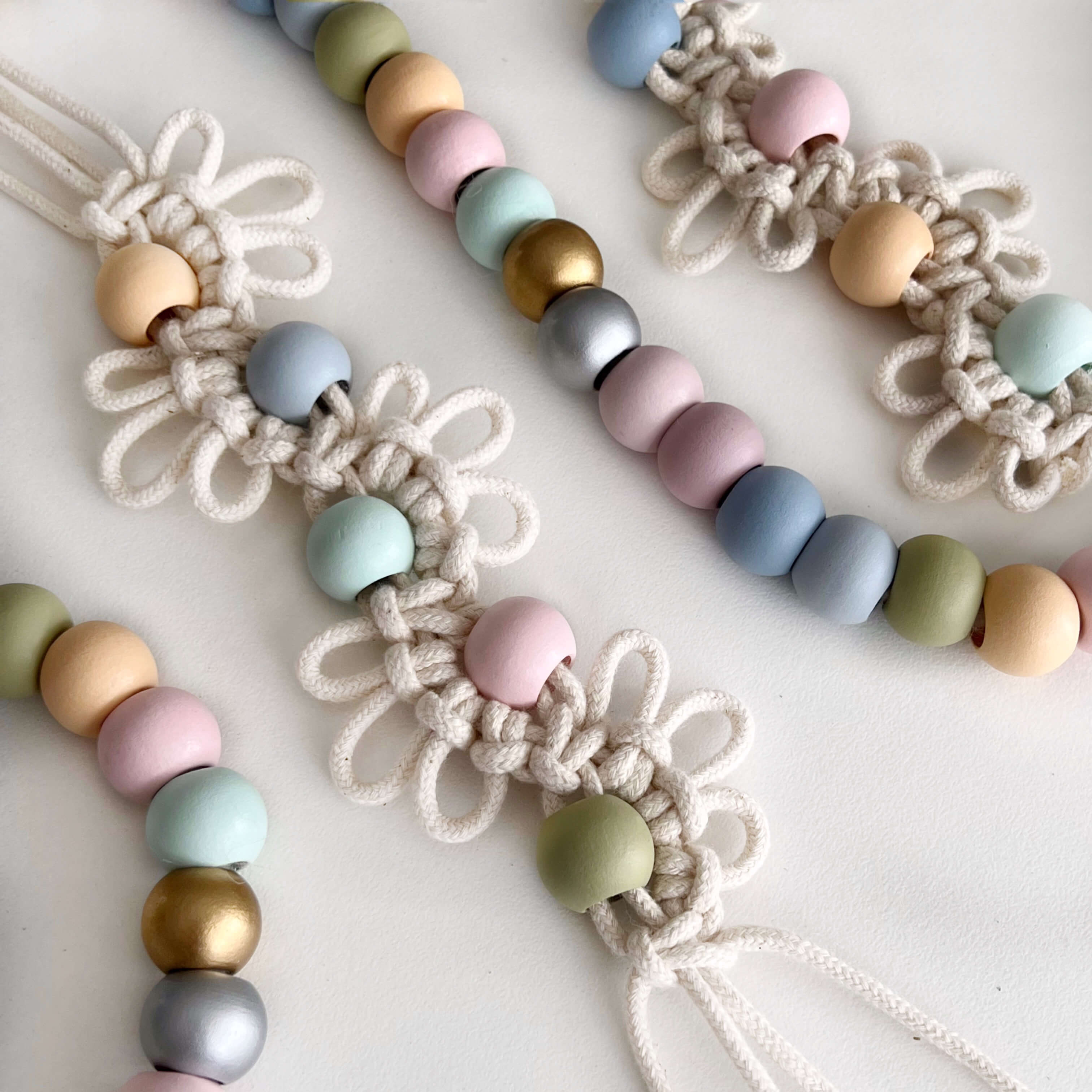 coloured wooden beads used in macrame wall hanging on display