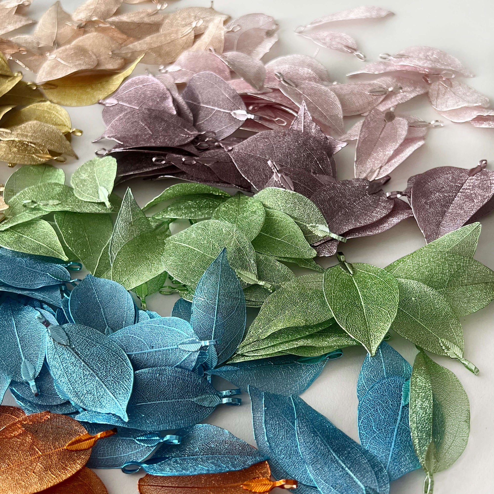 metal filigree leaves in assorted colours scattered on desk