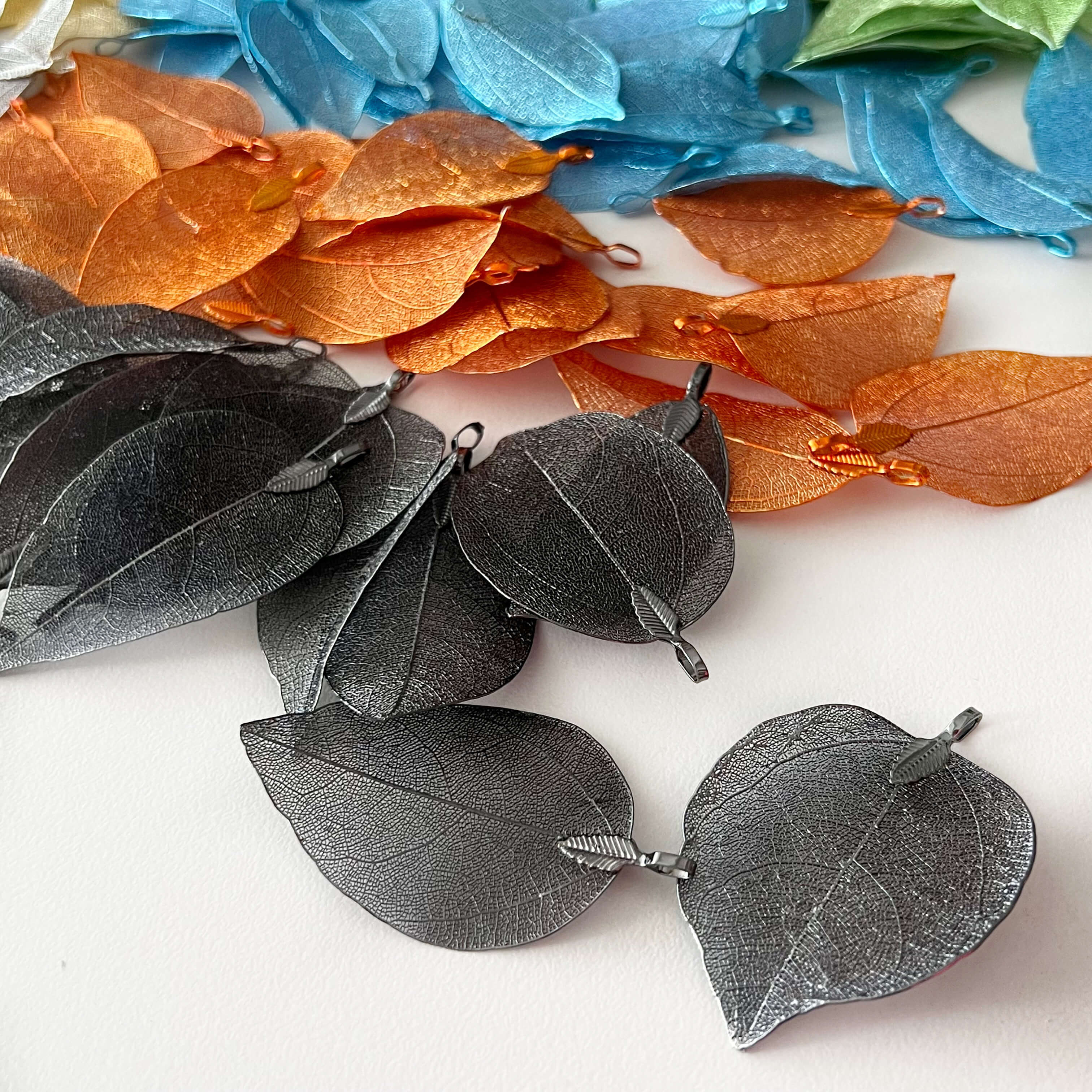 upclose image of black orange and blue filigree leaves to show intricate details in design