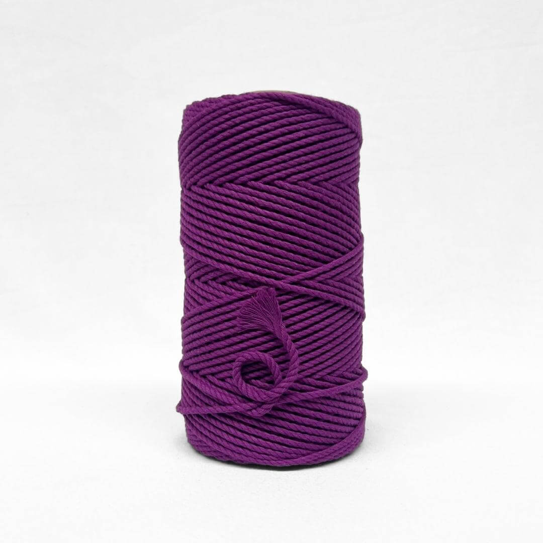 one roll of vibrant grape purple 4mm recycled macrame cord in white background small brushed piece showcasing products softness 