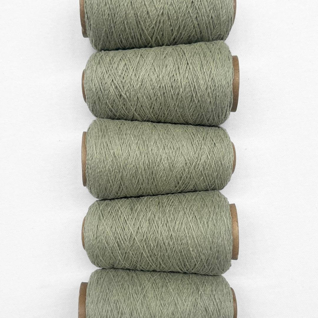 5 rolls of sage green wool rope laying side by side in flat lay image on white background 