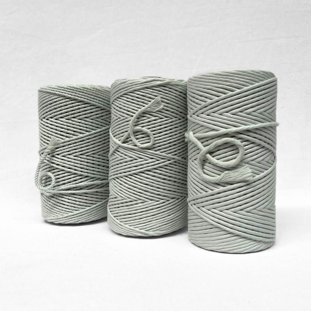 soft muted icy green 3ply 4mm cotton recycled rope on white backdrop small brushed piece to highlight the products softness