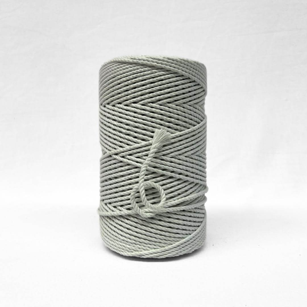 soft muted icy green 3ply 4mm cotton recycled rope on white backdrop small brushed piece to highlight the products softness