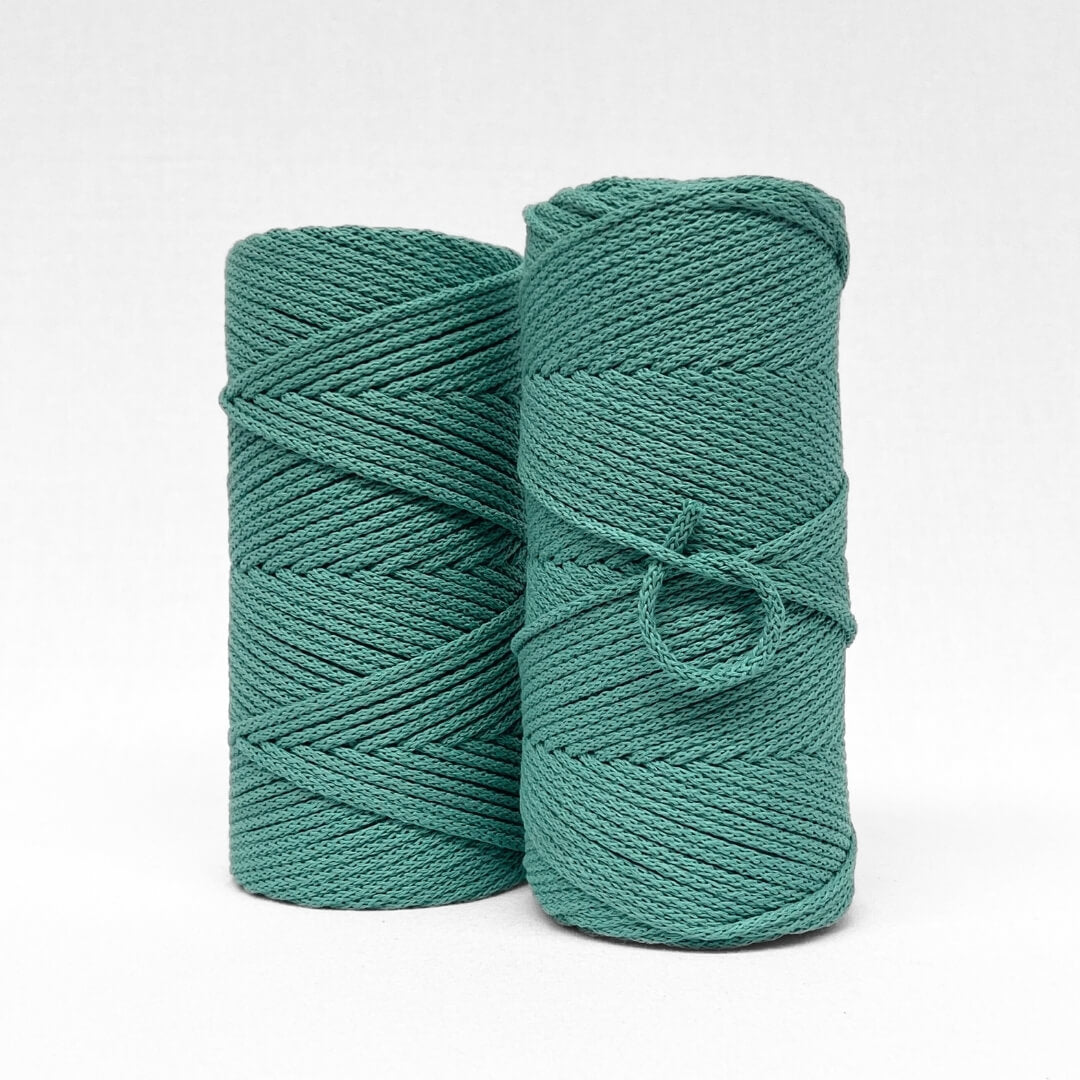 blue turquoise braided 4mm cotton cord standing side by side on white back drop