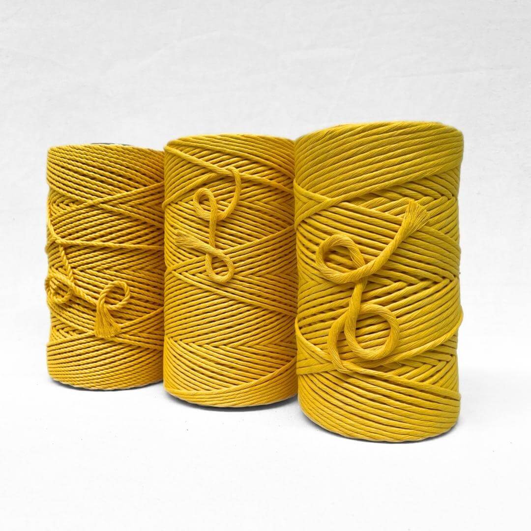 one roll of vibrant sunflower yellow recycled 4mm rope for macrame and diy crafts on white back ground