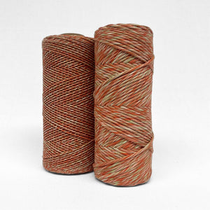 red and green mixed macrame string in 1.5mm and 4mm standing side by side on white wall
