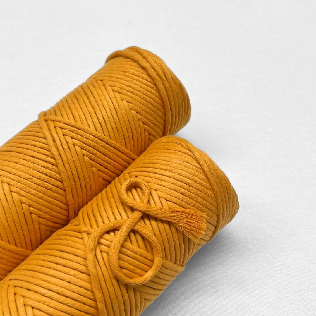 two rolls of mellow marigold laying flat on angle with white background