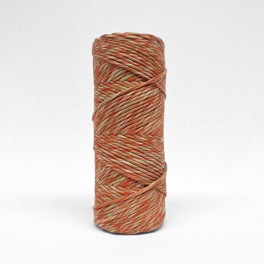 single roll of 4mm mixed macrame cord in red and green colour way on white background