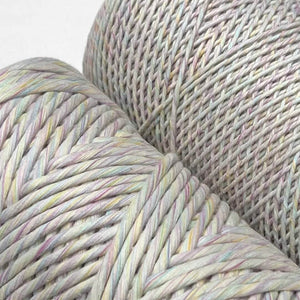 close up image of two rolls of rainbow swirl macrame cord showing pastel colour mix