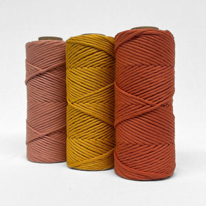 combination image showing three rolls in red earth marigold and rosewood standing side by side on angle wit white background