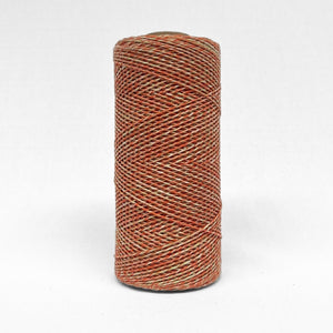 single roll of1.5mm string in red and green colours standing upright on white background
