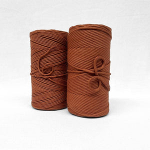 rust brown 3mm and 5mm string cotton rolls standing side by side on white wall