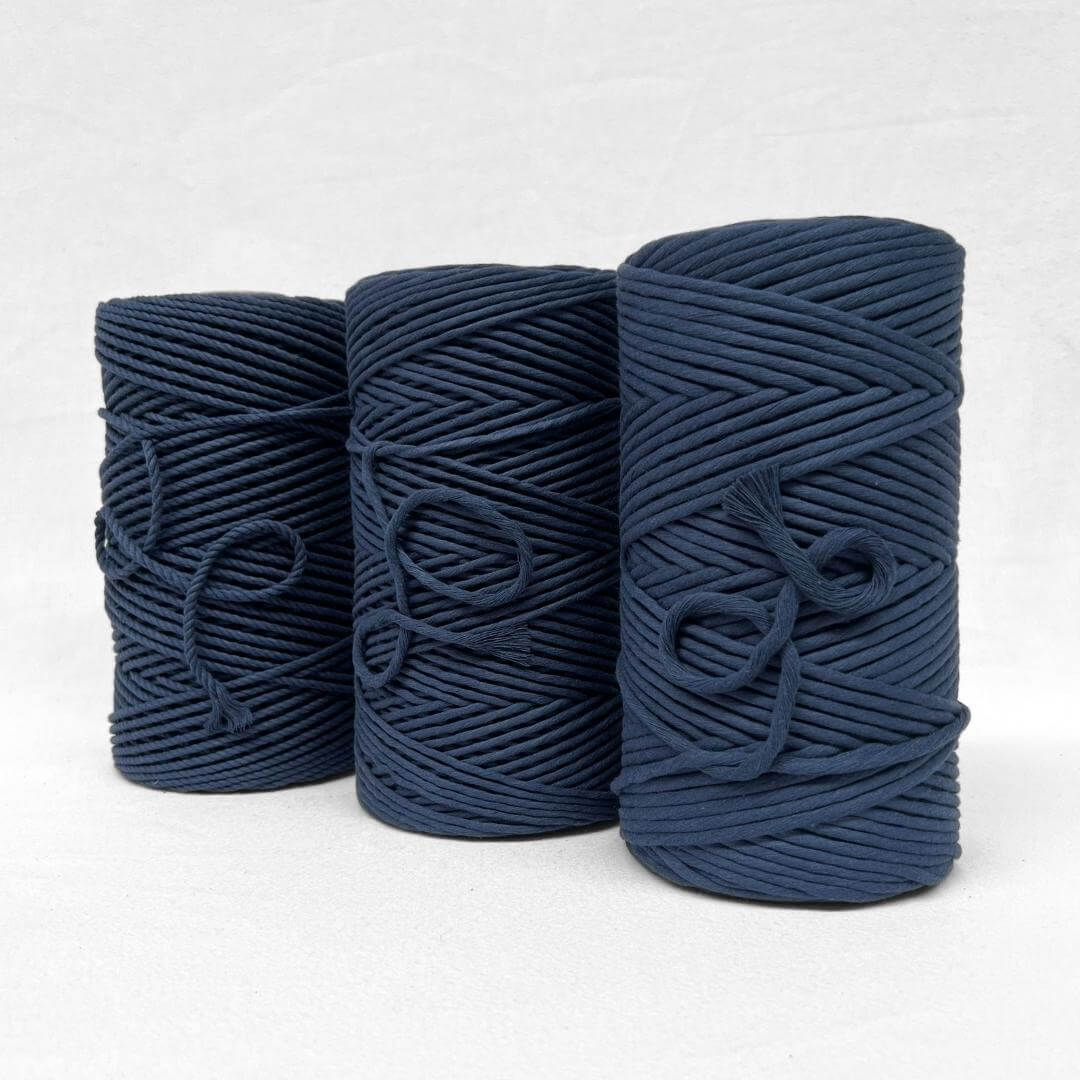 deep navy blue 4mm 3ply cotton macrame cord close up image of single roll standing with white background